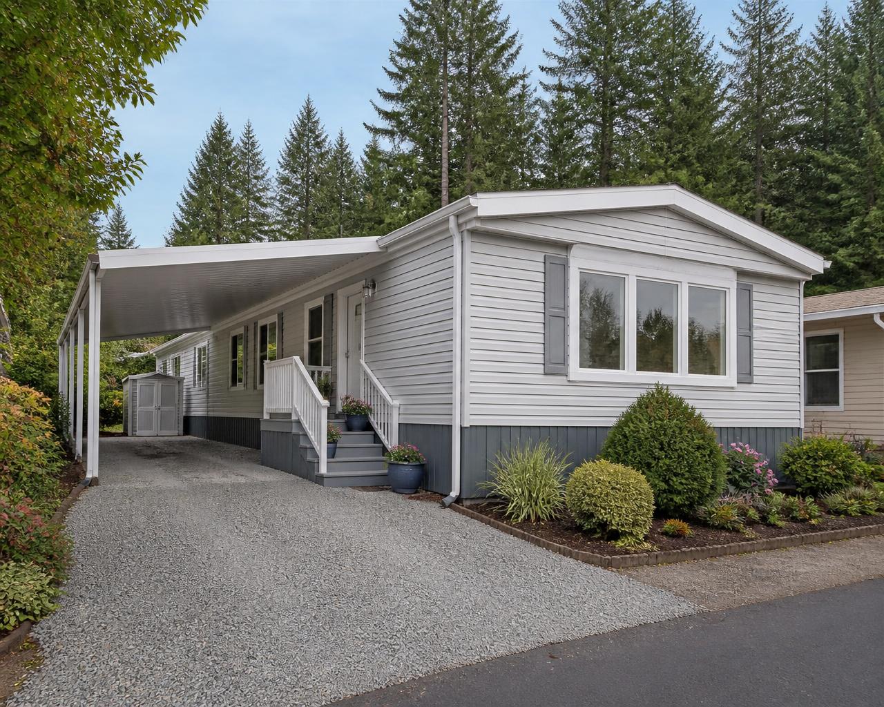 Well-maintained manufactured home with a carport in a Pacific Northwest community